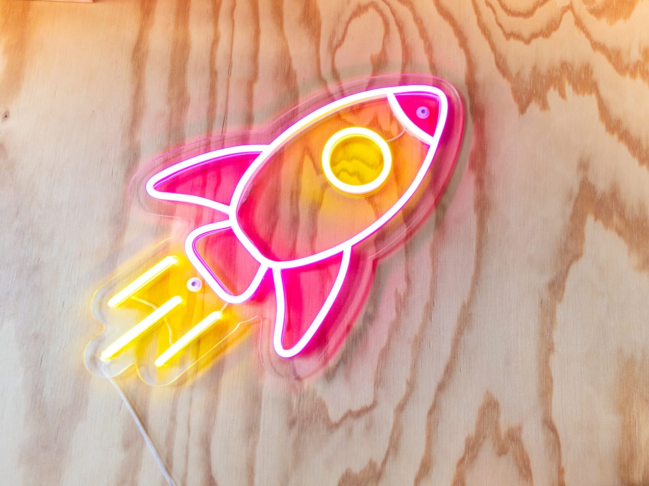 Pink Rocket Lamp on wood wall